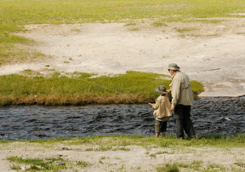 Grandfather and grandson fishing in Yellowstone