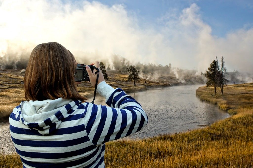 Woman taking a picture of a landscape