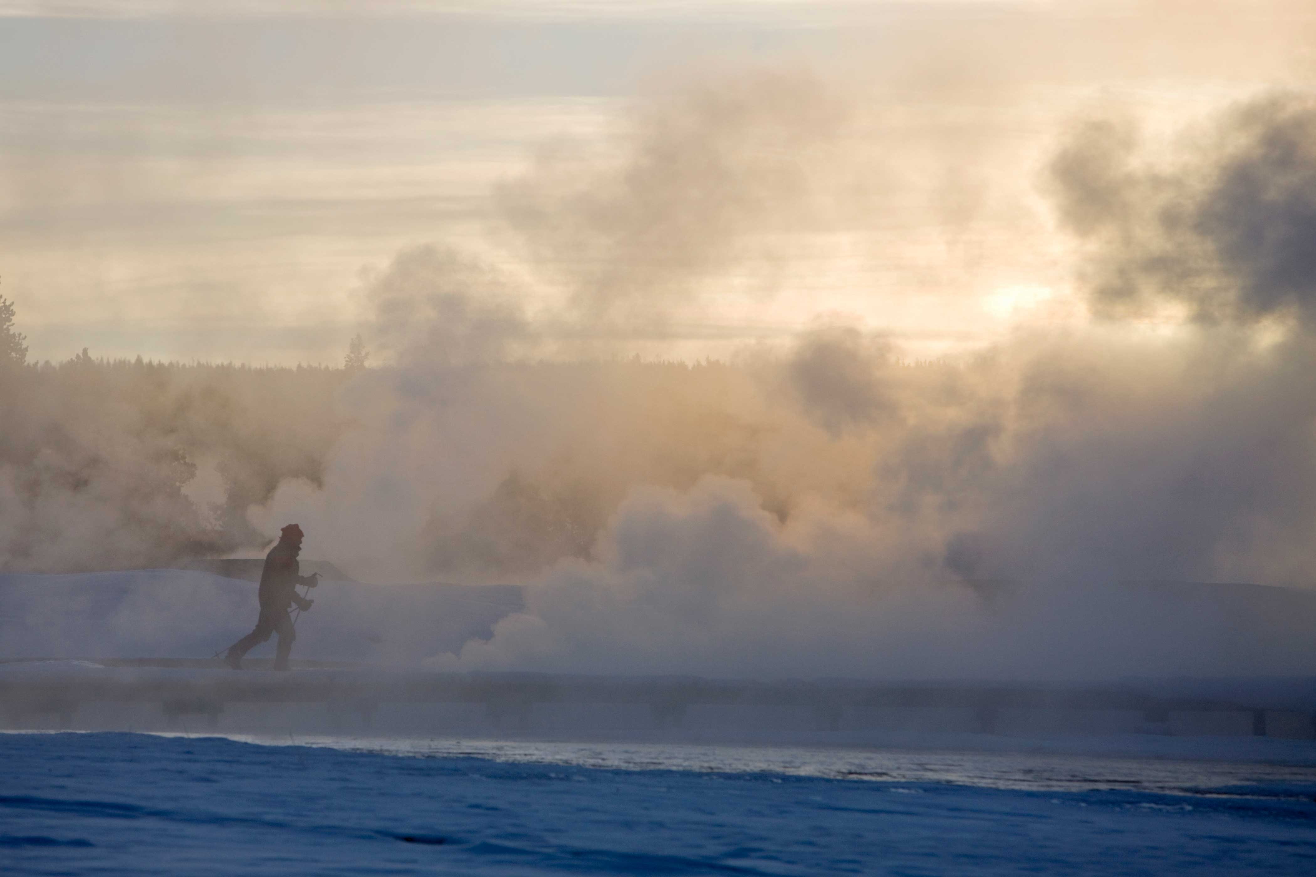 A Skier passing Thermals close to Old Faithful