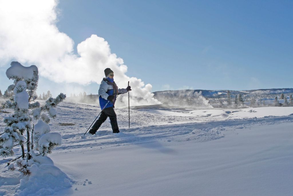 Person cross-country skiing at Old Faithful