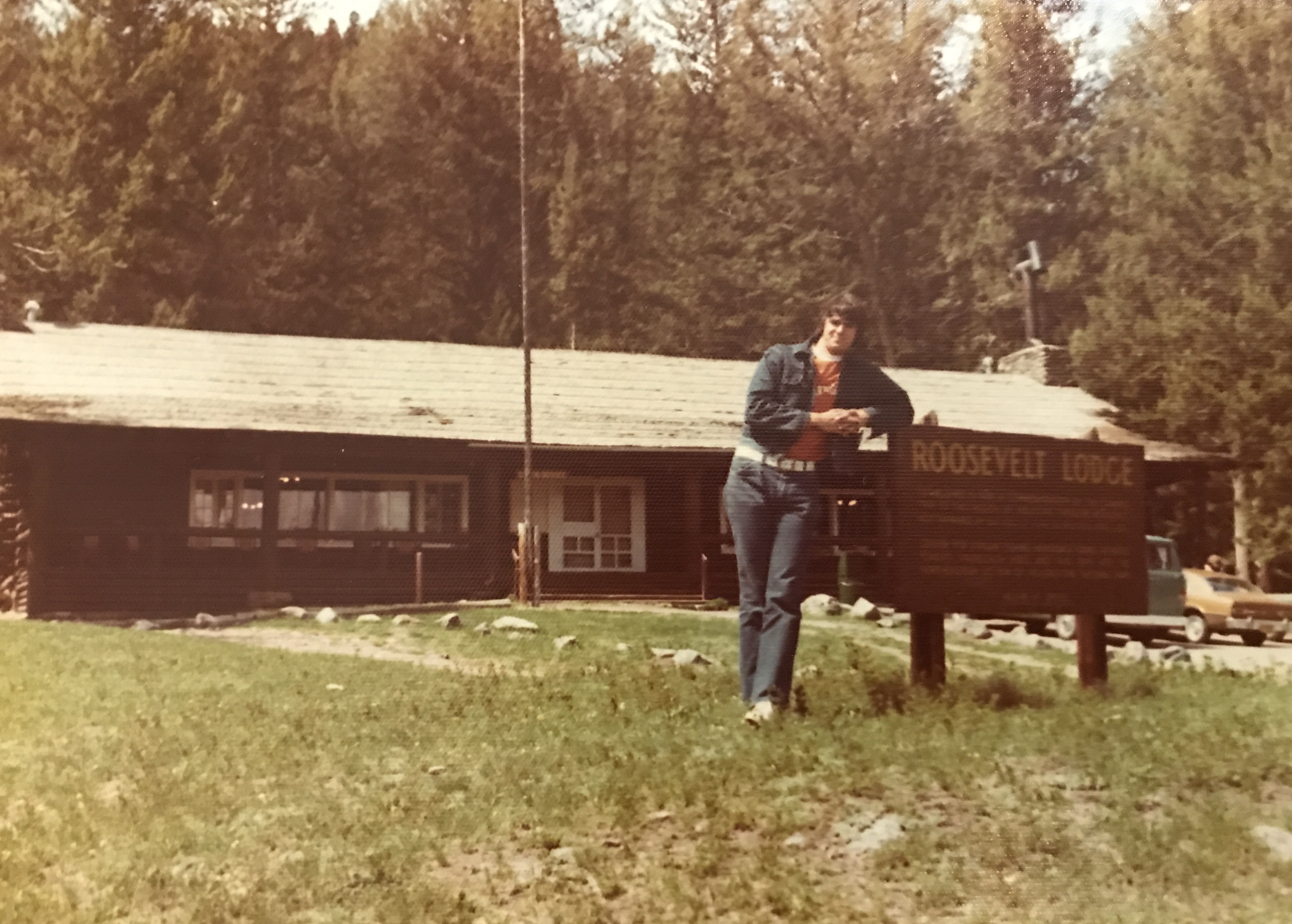 Employee standing in front Roosevelt Lodge