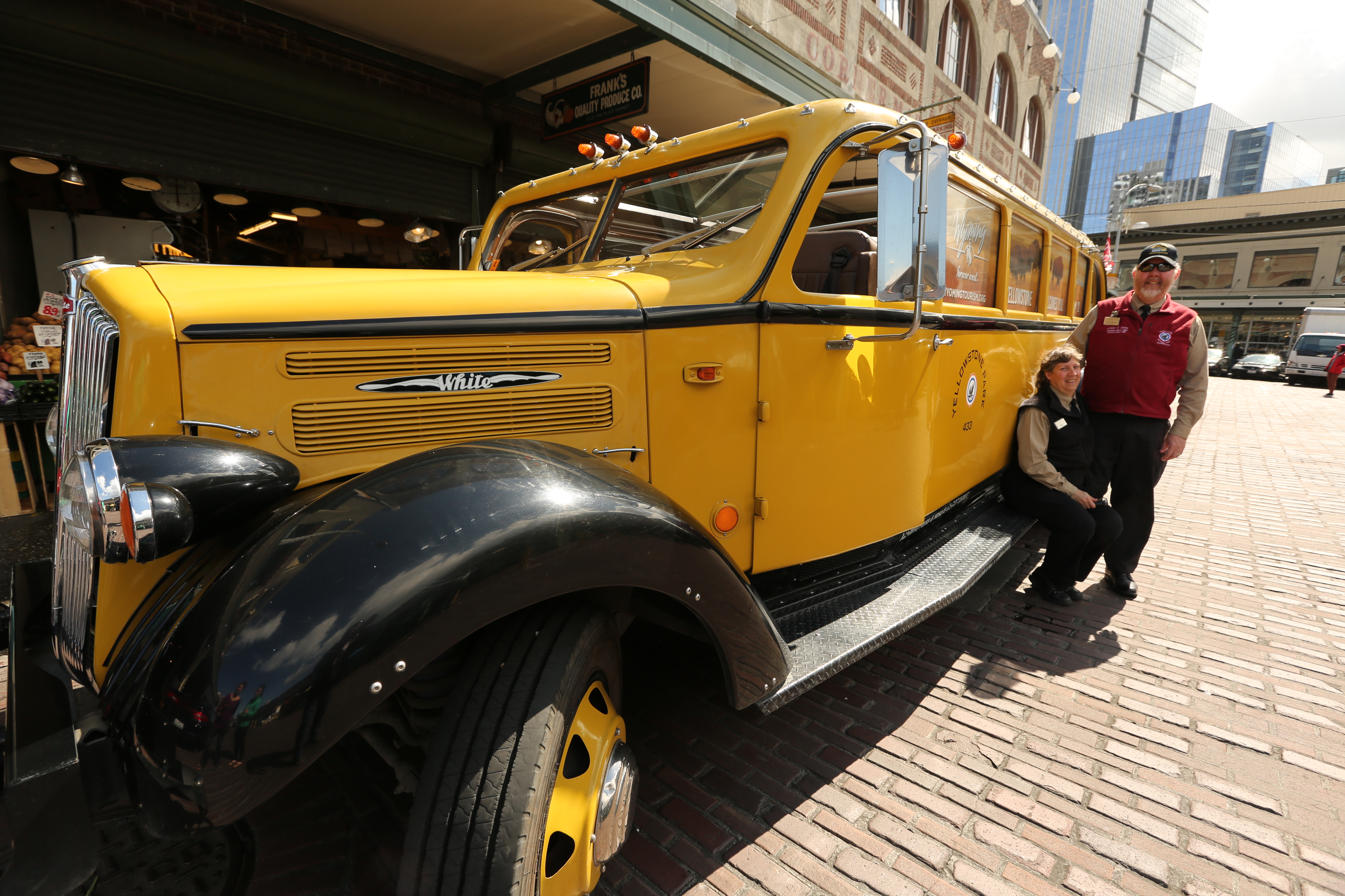 The Quinns pose next to a famous Yellowstone bus