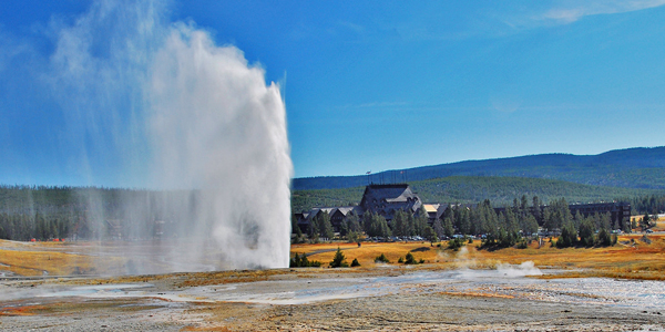 Old Faithful Inn with geyser