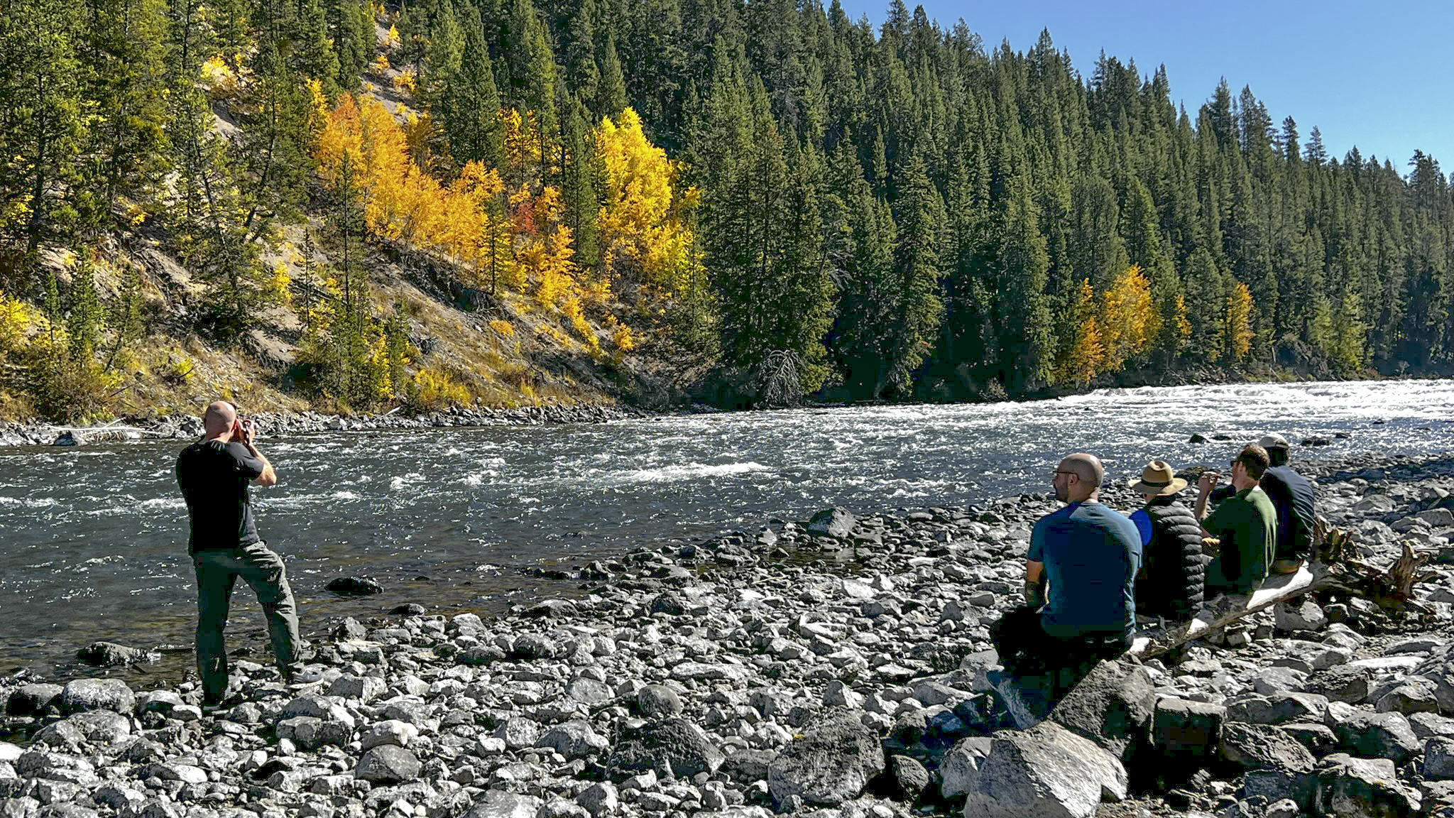 Photographer and group enjoying fall views of the Yellowstone River