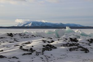 Ice sheets on the shore of Yellowstone Lake with mountains in the background