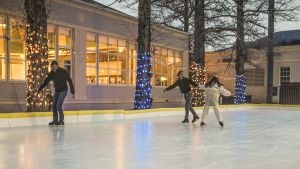 Man with two children skating at Mammoth Hot Springs Hotel