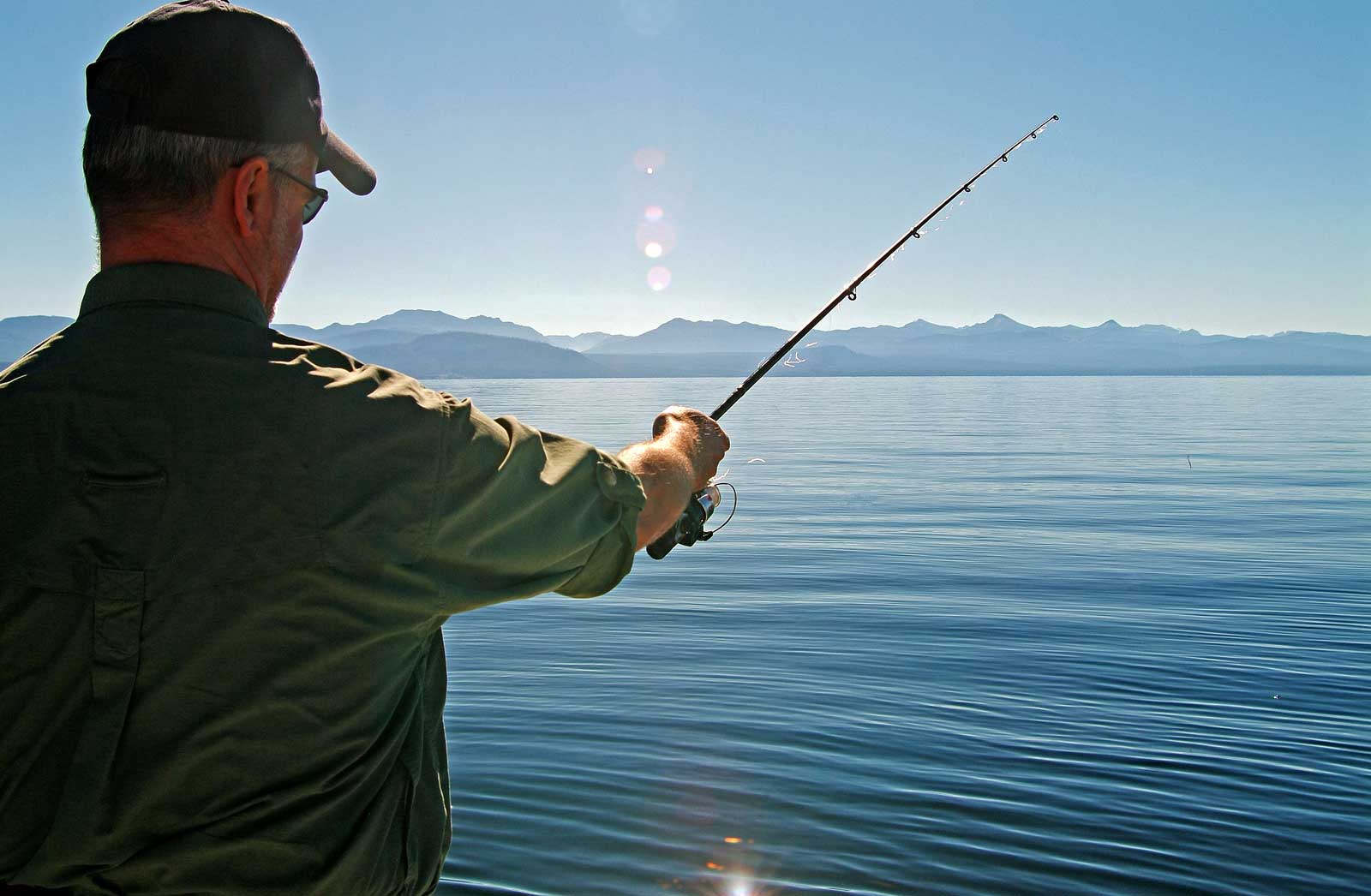 Man fishing out of a large lake