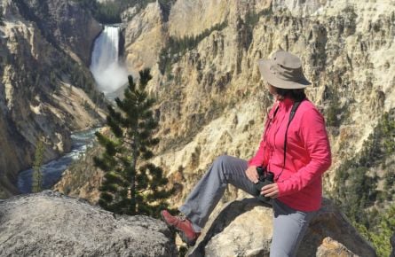 Woman looking at waterfall and Yellowstone