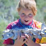 Young girl holding animal bones