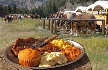 Cookout plate with horses and stagecoaches in the background