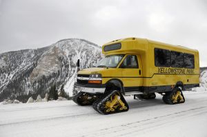 Glaval snowcoach with snowy hills in the background