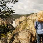 Woman watching waterfall at Grand Canyon of Yellowstone