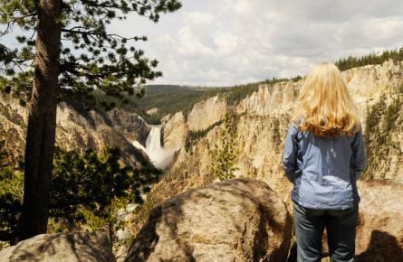 Woman watching waterfall at Grand Canyon of Yellowstone