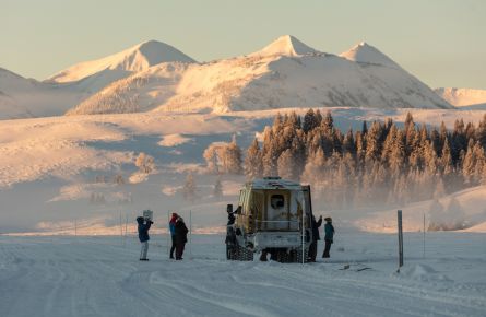 Snowcoach sunrise on Swan Lake Flat