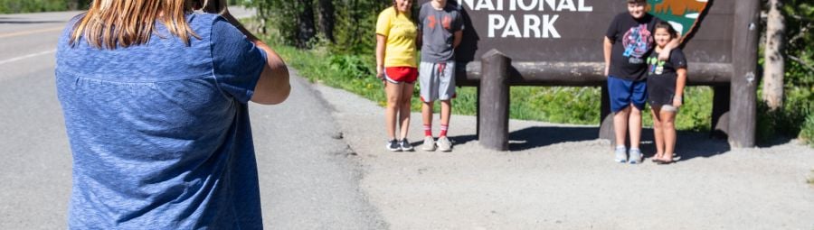 Family photo at the East Entrance park sign