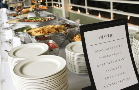 Buffet table with menu and food.