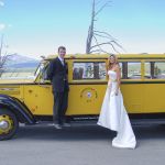 Bride and Groom outside a historic yellow bus