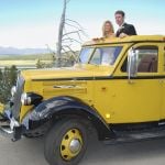 Bride and Groom inside a historic yellow bus