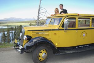 Bride and Groom inside a historic yellow bus