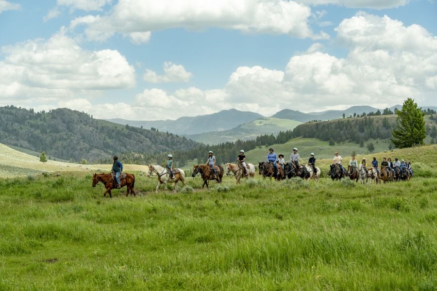 Horseback riding tour in a valley with mountains