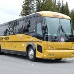 Yellow Motorcoach Tour Bus parked in a pull-out