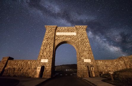 The Milky Way appears behind the Roosevelt Arch at the North Entrance to Yellowstone National Park